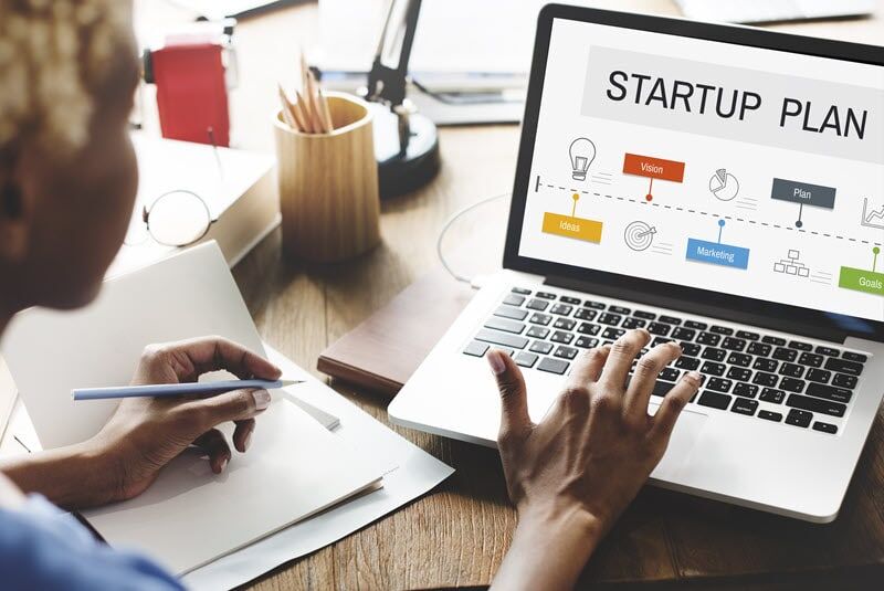 A woman works on a plan for medical device startup companies